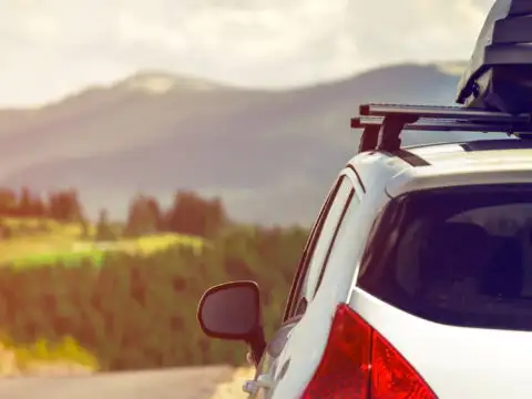 Car on a mountain road with a roof cargo carrier
