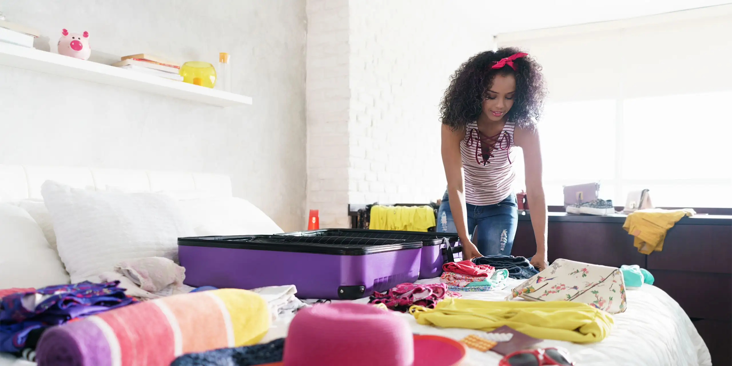 Woman Packing Suitcase; Courtesy of Diego Cervo/Shutterstock.com